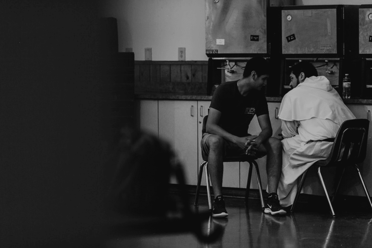 A priest administers the sacrament of Confession. 